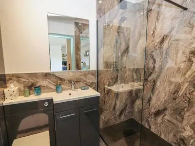 a bathroom with a sink and a mirror at Bryn Hafod in Llandrindod Wells