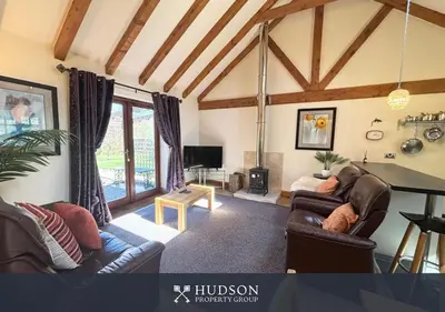a living room with two couches and a table at Private Cottage in Shrewsbury in Shrewsbury