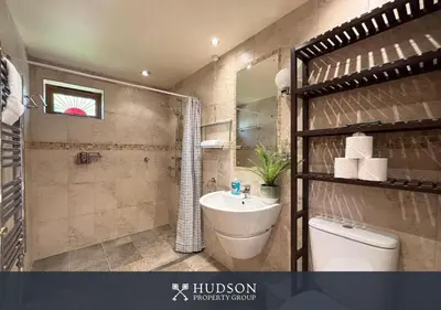 a bathroom with a sink and a shower and a toilet at Private Cottage in Shrewsbury in Shrewsbury