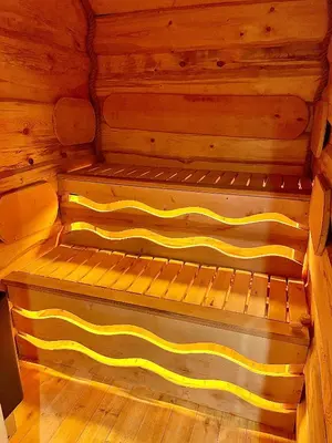 a wooden interior of a sauna with yellow stripes at The Viking Lodge with Sauna in Ystrad-Meurig