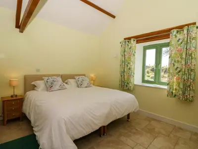 a bedroom with a bed and a window at Cwtch in Ystrad Meurig