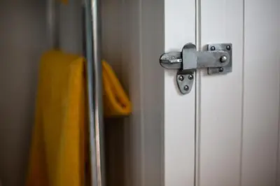 a door with a metal door knob and a yellow bag at Beautiful Cabin Near Hay-on-Wye in Peterchurch
