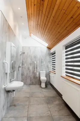 a bathroom with a toilet and a sink and a mirror at Cambrian Farm House by Birch Stays in Devils Bridge