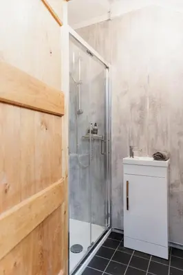 a bathroom with a shower and a sink at Cambrian Farm House by Birch Stays in Devils Bridge