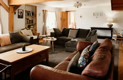 a living room with a couch and a table at Cambrian Farm House by Birch Stays in Devils Bridge