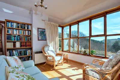 a living room with a couch and chairs and windows at Finest Retreats - Cwmfron House in Llanidloes