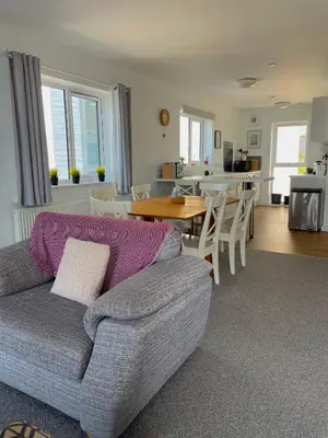 a living room with a couch and a table at Duplex apartment with spectacular sea views! in Aberystwyth