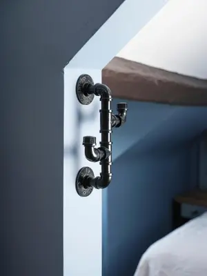 a black water pipe attached to a wall at The Bryntirion Inn in Llandderfel