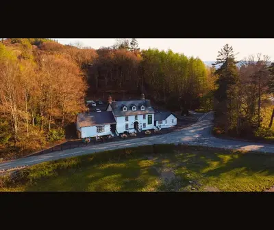 a large white house on the side of a road at The Bryntirion Inn in Llandderfel