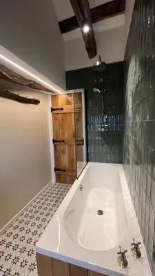 a bathroom with a white tub and a shower at Peaceful Dyfi Valley Cottage - Hendre-gau in Machynlleth