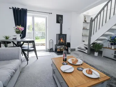 a living room with a couch and a fireplace at The Coach House in Dolgellau