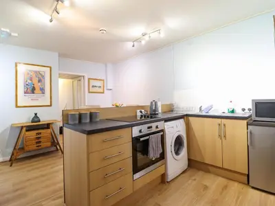 a kitchen with a stove and a dishwasher at Beach Haven in Aberystwyth