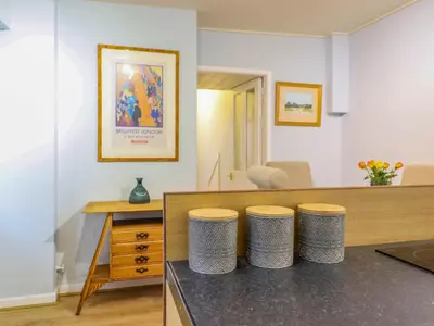 a room with a counter with three stools at Beach Haven in Aberystwyth