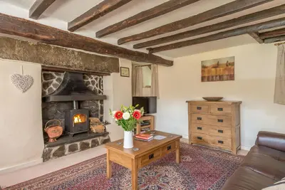 a living room with a couch and a fireplace at Ty-Mawr in Llanuwchllyn