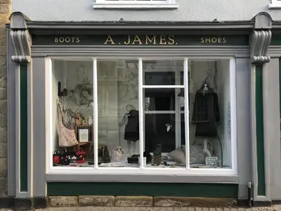 a store window with the words books a james shops at Cosy Cottage in Kington