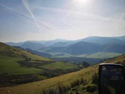 a view of a valley from the side of a car at Family-Friendly Woodland Caravan Pool & Bar in Bryn-glâs Station