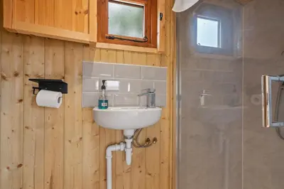 a bathroom with a sink and a shower at Off-Grid Glamping - Quiet, Starry Escape in Yarpole
