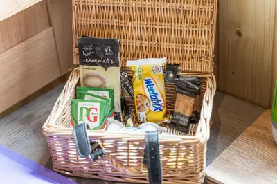 a basket filled with food and other items on a table at Off-Grid Glamping - Quiet, Starry Escape in Yarpole
