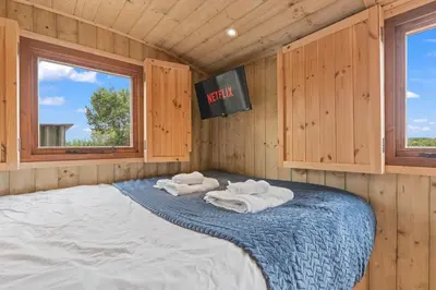 a bedroom with a large bed with towels on it at Unplug & Reconnect, Romantic Retreat with Hot Tub in Yarpole