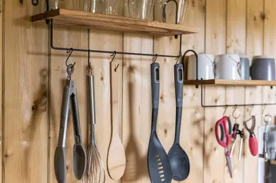 a bunch of kitchen utensils hanging on a wall at Unplug & Reconnect, Romantic Retreat with Hot Tub in Yarpole