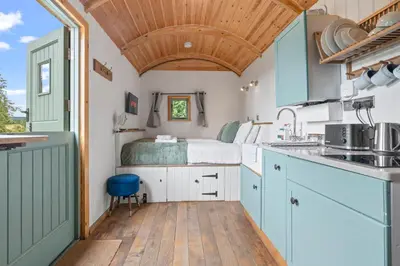 a kitchen with a bed in a tiny house at Hot Tub Luxury Glamping - Private Stargazing Patio in Yarpole