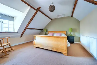 a bedroom with a wooden bed in a attic at Finest Retreats - Yr Daflod in Brecon