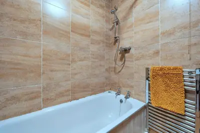 a bathroom with a bath tub and a shower at Finest Retreats - Yr Daflod in Brecon