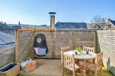 a patio with a table and chairs on a balcony at Finest Retreats - Yr Daflod in Brecon