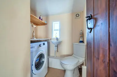 a bathroom with a toilet and a washing machine at Finest Retreats - Yr Daflod in Brecon