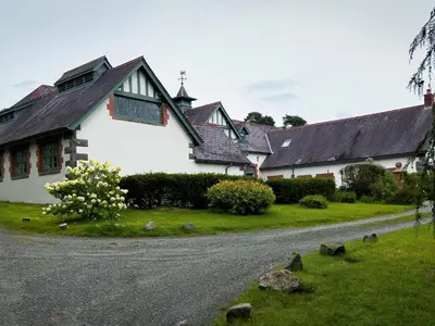 a white house with a road in front of it at Coach House in Llanwrtyd Wells