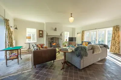 a living room with a couch and a table at Coach House in Llanwrtyd Wells