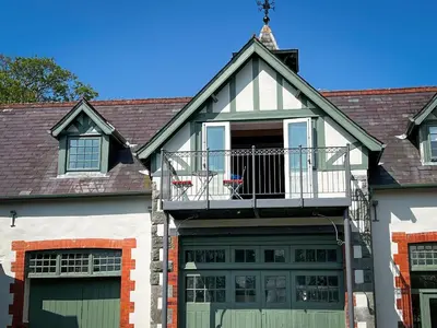 a house with a balcony on top of it at Coach House in Llanwrtyd Wells
