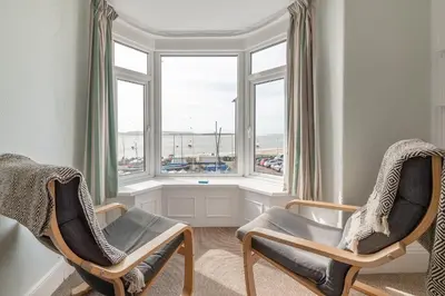 two chairs in a room with a window at Aberdyfi Sea View Apartment in Aberdyfi