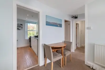 a dining room with a wooden table and chairs at Aberdyfi Sea View Apartment in Aberdyfi