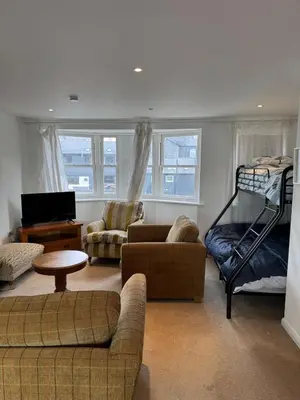 a living room with a couch and a bunk bed at Modern, sleeps 6, rural market town, Llani in Llanidloes