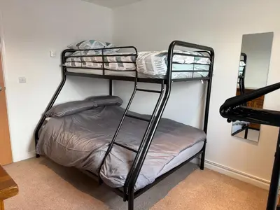 a room with two bunk beds in a room at Modern, sleeps 6, rural market town, Llani in Llanidloes