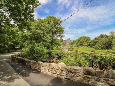 a stone wall on the side of a road at Ty Glan Yr Afon in Dolgellau