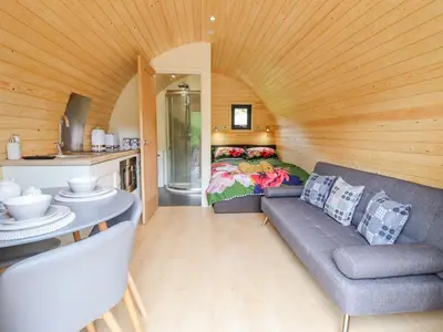 a living room with a couch and a bed at Briallen in Dolgellau