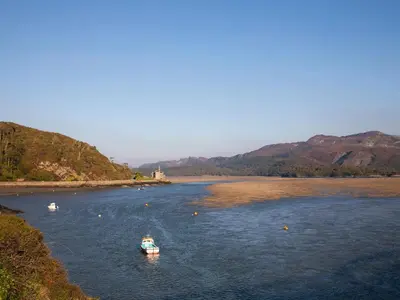 two boats in a river with mountains in the background at Eirlys in Dolgellau