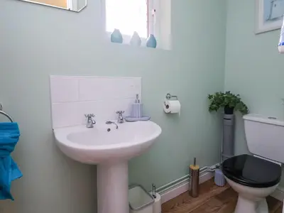a bathroom with a sink and a toilet at 2 Mountain View in Wrexham