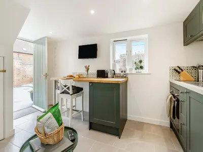 a kitchen with green cabinets and a counter top at The Little House - Uk49129 in Stapleton