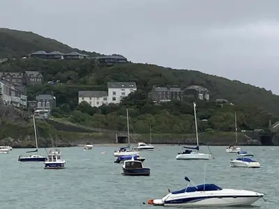 a group of boats sitting in the water at The Cottage on the Rock in Barmouth