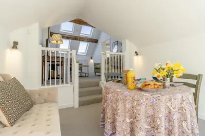 a dining room with a table with flowers on it at 1 Bed in Culmington oc-t31830 in Culmington