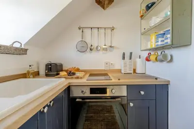 a kitchen with blue cabinets and a sink at 1 Bed in Culmington oc-t31830 in Culmington