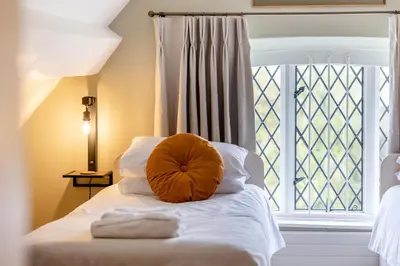 a bed with a pillow on it in front of a window at 2 Bed in Ludlow oc-c31883 in Ludlow