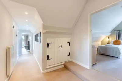 a white bedroom with a bed and a hallway at 2 Bed in Ludlow oc-c31883 in Ludlow