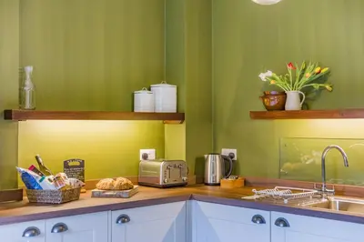 a kitchen with green walls and a counter with a sink at 2 Bed in Ludlow oc-s31884 in Ludlow