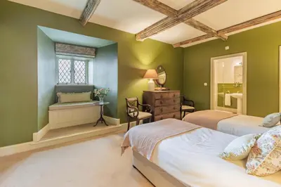 a green bedroom with two beds and a window at 2 Bed in Ludlow oc-s31884 in Ludlow