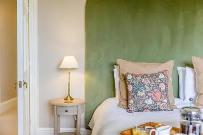 a bedroom with a bed with a green wall at 2 Bed in Ludlow oc-p31882 in Ludlow