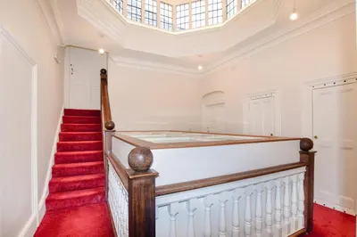 a home with a red carpet staircase and a skylight at 2 Bed in Ludlow oc-p31882 in Ludlow